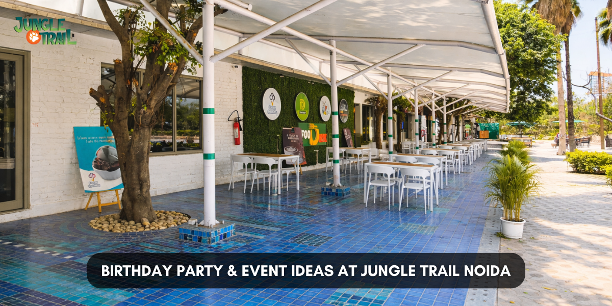 Birthday Party & Event Ideas at Jungle Trail Noida,” showing an outdoor restaurant seating area with white tables, a covered canopy, greenery wall decor, and blue tiled flooring.