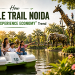 Jungle Trail Family enjoying a paddle boat ride at Jungle Trail Noida with large recycled metal animal sculptures, greenery, and adventure activities, highlighting the experience economy trend through nature, creativity, and family entertainment.