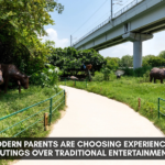 Family walking through a lush green jungle trail park with animal sculptures, showcasing experience-based outdoor activity for modern parents