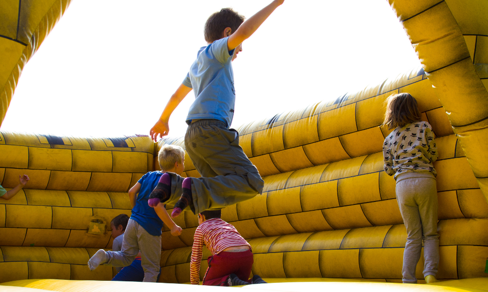 children playing inside the bouncy castles
